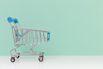 Empty shopping cart on light blue background