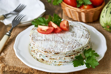 Zucchini cake with tomatoes and fresh parsley