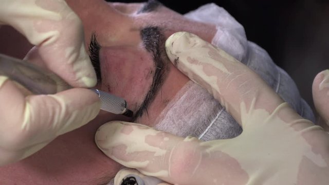 Young girl doing microblading procedure