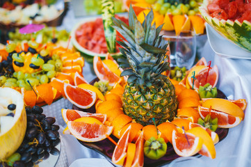 Photo of full table of sliced tropical fruits