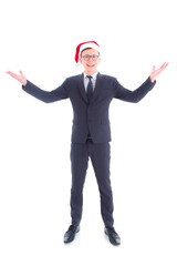 Full length of handsome asian businessman wearing suit and santa claus hat standing and smiling isolated over white background