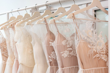 wedding dresses hanging on racks