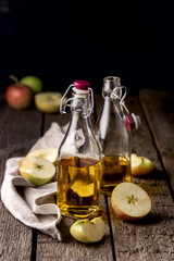 Apple Vinegar Bottles of Apple Organic Vinegar or Cider on Wooden Background Healthy Organic Food Vertical Dark Photo
