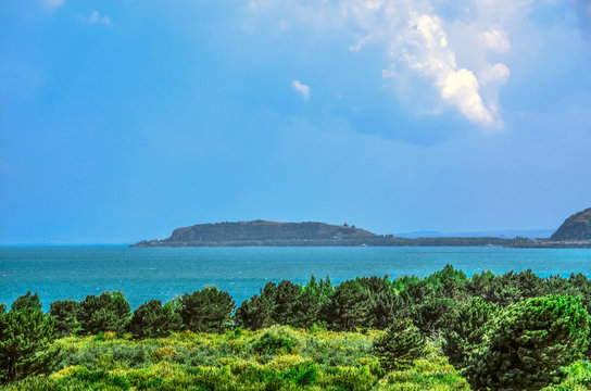 Lake Sevan and in the distance you can see the Peninsula with the medieval monastery Sevanavank of the 9th century, located in Gegharkunik region of Armenia