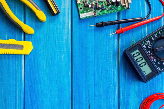 Services for the production of electronics and repair on a wooden blue background.