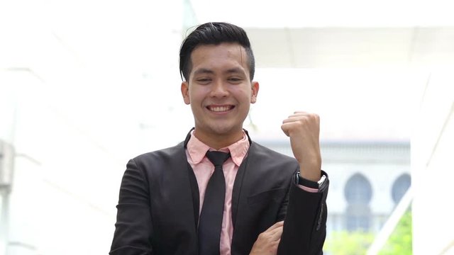 Young business man celebrates success