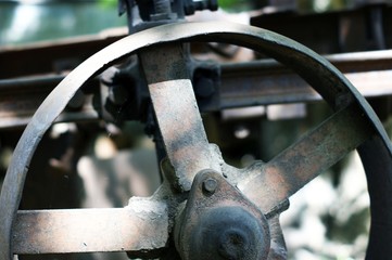 Old rusty plow, details against the background of firewood.
