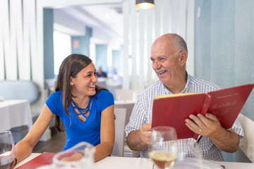 Mature man and young woman enjoying and smiling, spending time together