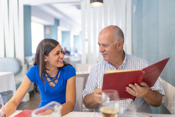 Mature man and young woman enjoying and smiling, spending time together
