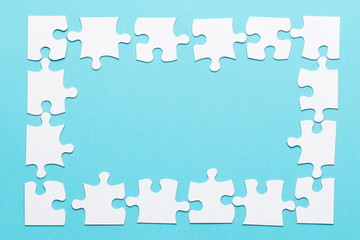 High angle view of jigsaw puzzle frame on blue backdrop