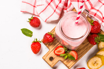 Strawberry milkshake or smoothie in mason jar.