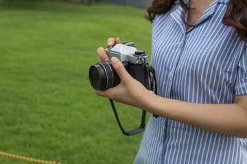 young woman photographer with vintage film camera.