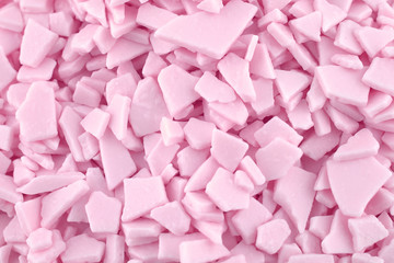 Candy chocolate background, copy space. Closeup of pile pastel chocolate candies. Candy texture. Candy pattern. Sweets background. Pink abstract background. Top view, flat lay