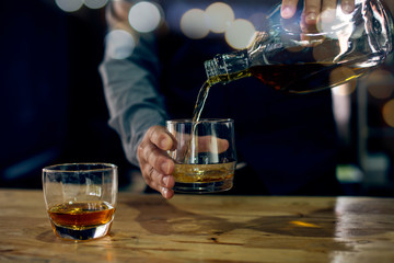 glass of brandy and cigar on table