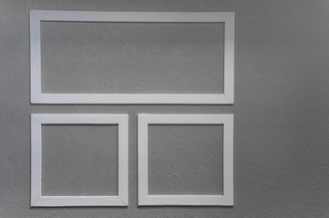 Close-up of three white picture frames