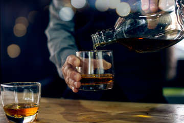 bartender pouring beer in glass