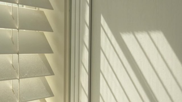 Sunshine through blinds. Timelapse of sun through window