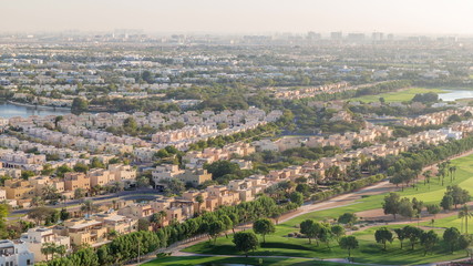 Aerial view to villas and houses with Golf course with green lawn and lakes timelapse