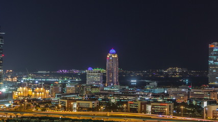 Fototapeta premium Dubai media city skyscrapers and golf course night timelapse, Dubai, United Arab Emirates