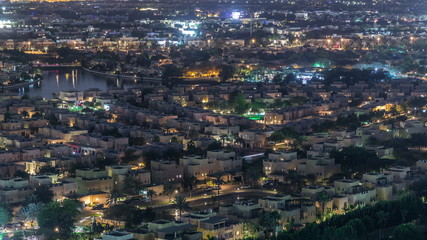 Fototapeta na wymiar Aerial view to villas and houses with Golf course night timelapse