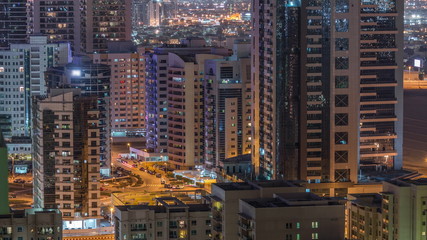 Tecom district skyscrapers aerial view from Greens district night timelapse