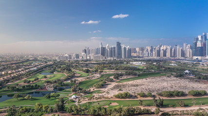 Fototapeta premium Dubai Marina skyscrapers and golf course morning timelapse, Dubai, United Arab Emirates