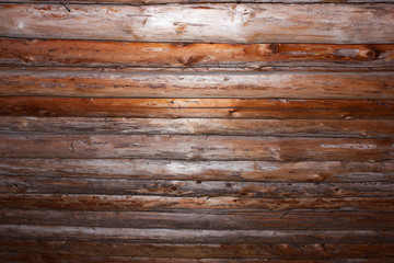lit ceiling made of round logs, view from below