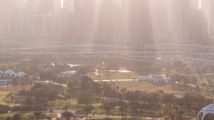 Golf course and Dubai Marina skyscrapers during sunset timelapse, Dubai, United Arab Emirates