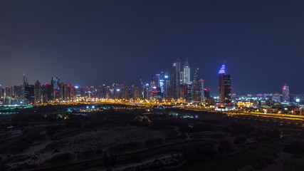 Dubai Marina skyscrapers and golf course all night timelapse, Dubai, United Arab Emirates
