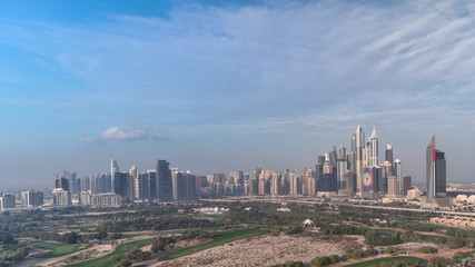 Naklejka na ściany i meble Dubai Marina skyscrapers and golf course morning timelapse, Dubai, United Arab Emirates