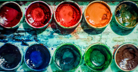 Sheet of paper and old watercolor paints