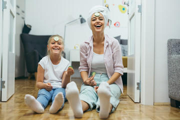 happy family time. mother and daughter skin treatment at home