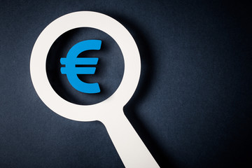 Checking finance with magnifying glass