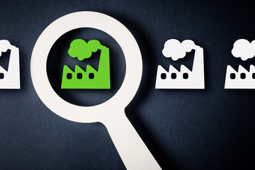 Checking factory with magnifying glass