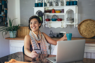 she is always on line with her friends. woman using laptop at her home