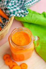 Carrot smoothie with parsley on a table