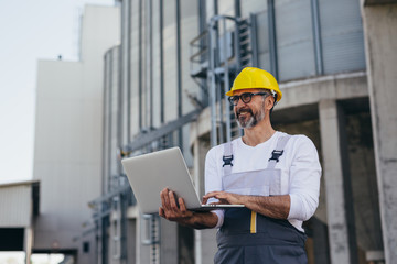 construction worker using laptop on site