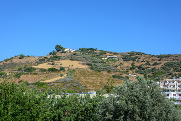 Fototapeta na wymiar mountain view with single Mediterranean houses, trees and gardens