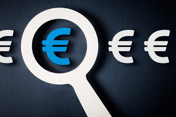 Checking finance with magnifying glass