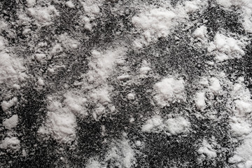 White powder on black background. Isolated abstract pattern for cooking, medical or chemical design decoration. Close up of crystals pile with random texture
