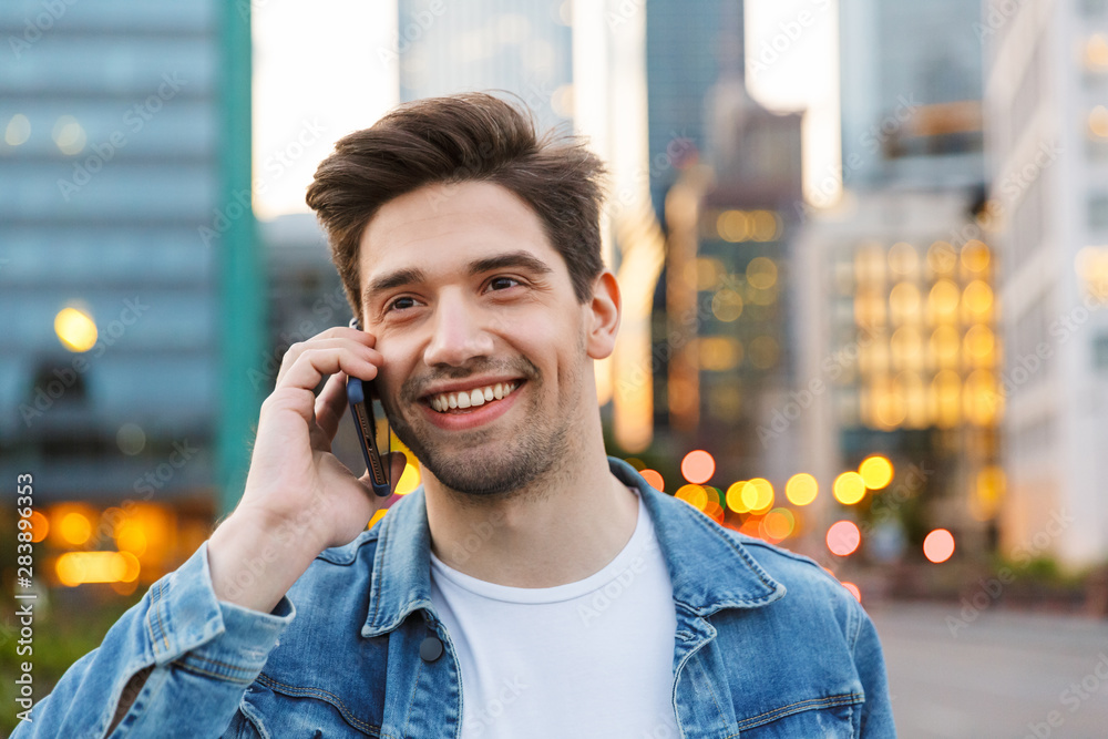 Poster Close up of a handsome smiling young man talking