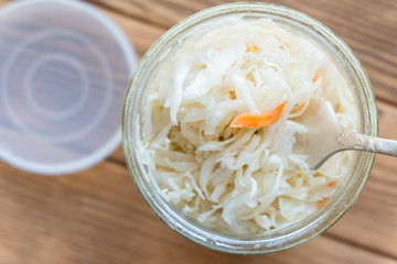 Salted cabbage in a glass jar. Marinated cabbage with carrots