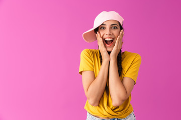 Naklejka premium Photo of excited joyful woman wearing cap smiling and touching her cheeks
