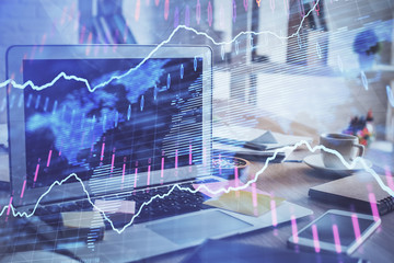 Financial market graph hologram and personal computer on background. Double exposure. Concept of forex.