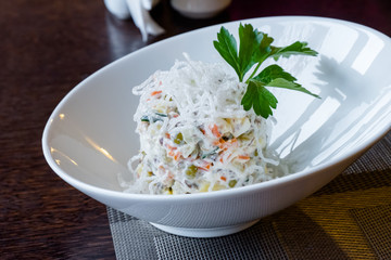 Beautiful Russian (winter) salad Olivier with vegetables and popped rice