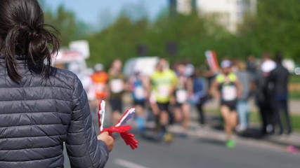 Woman cheering runners in 4k slow motion 60fps