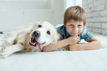 A child with a dog. Little boy with a dog at home. 