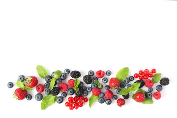 wild berries and mint leaves on a white background top view. blueberries, raspberries,...