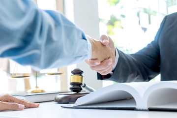 Lawyer or judge  with gavel and balance handshake