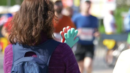Woman cheering runners in 4k slow motion 60fps